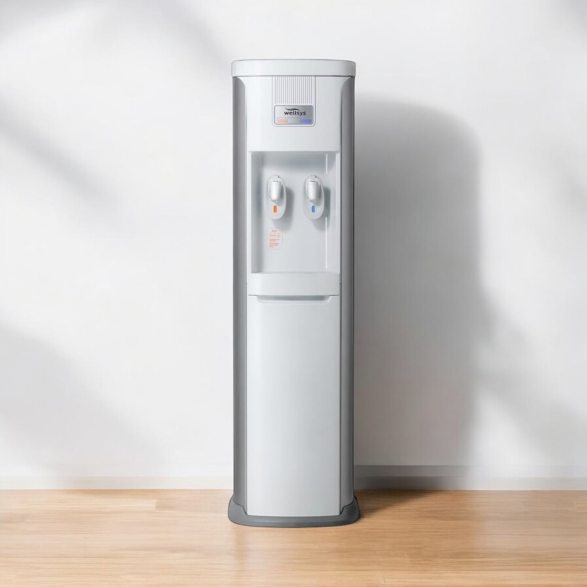 Load video: vidoe: How to change the filters in your water cooler. cover image is a Wellsys model 8020 water cooler sitting on hardwood floor in an empty room. 